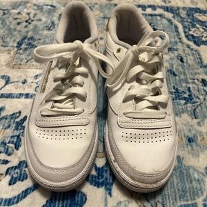 White Reebok with gold accents